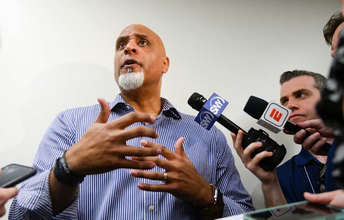 Manfred (top) and Clark are facing off over baseball's future.